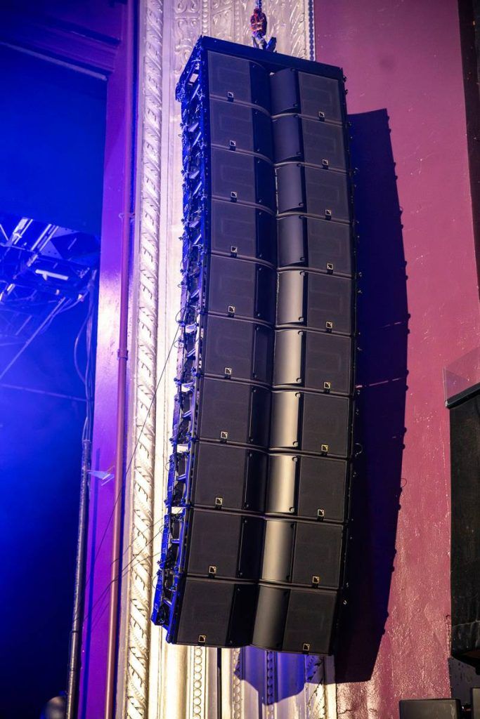 Arrays of ten L-Acoustics K3 enclosures flank the stage