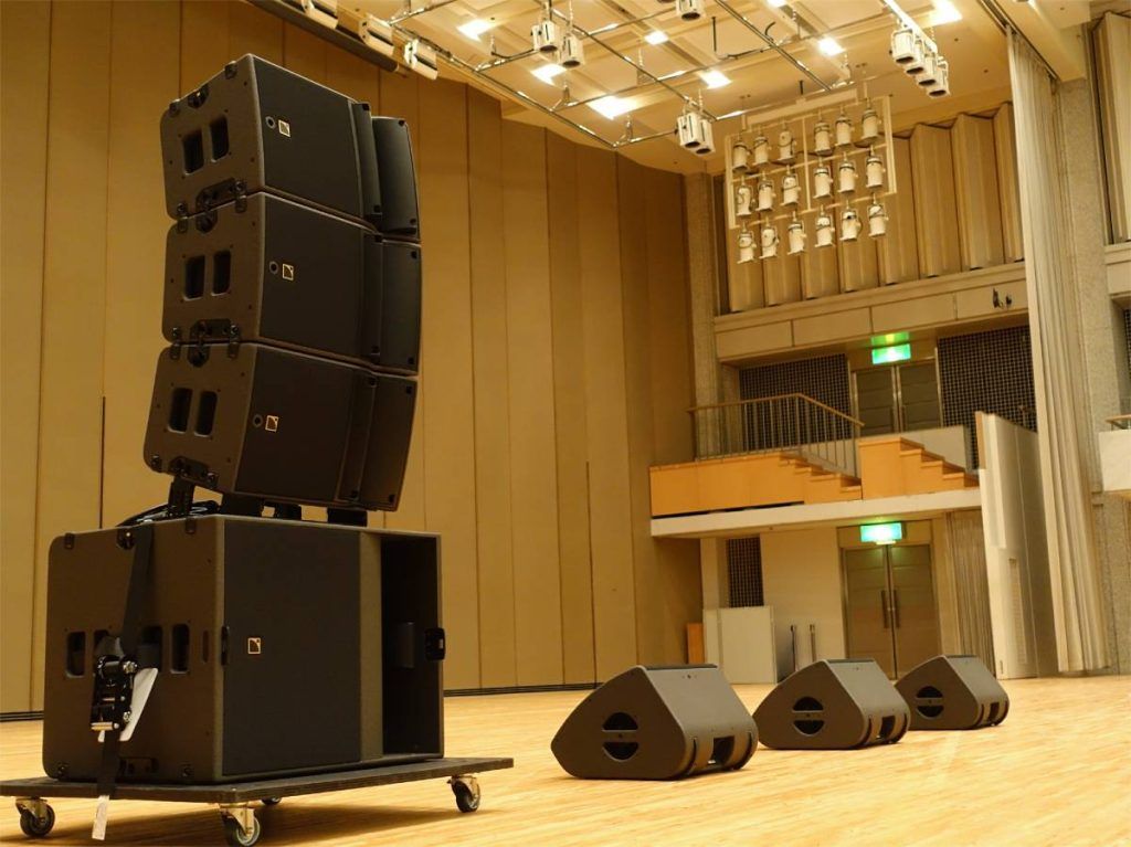 A mobile professional sound system of three L-Acoustics A10 Focus atop one KS21 subwoofer and three L-Acoustics X12 for stage monitoring