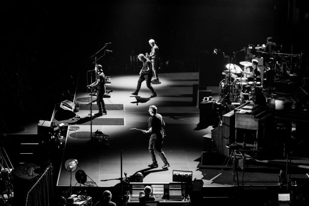 L-Acoustics K3 concert sound system enclosures, used for stage monitoring, are hidden under the steel grating to the left and right of singer Eddie Vedder (pc: Geoff Whitman)