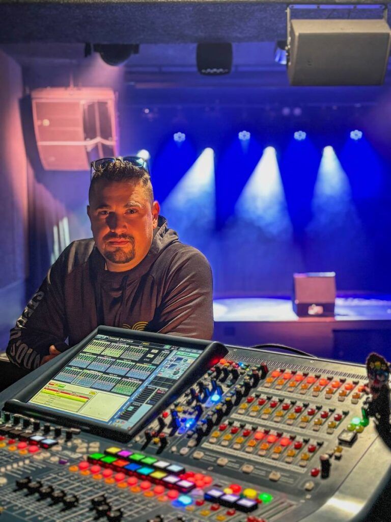 Audio technician Eric Jones at the Main Stage’s pre-existing Midas PRO2 FOH console, with an L-Acoustics A15i array and X8 fill also in view