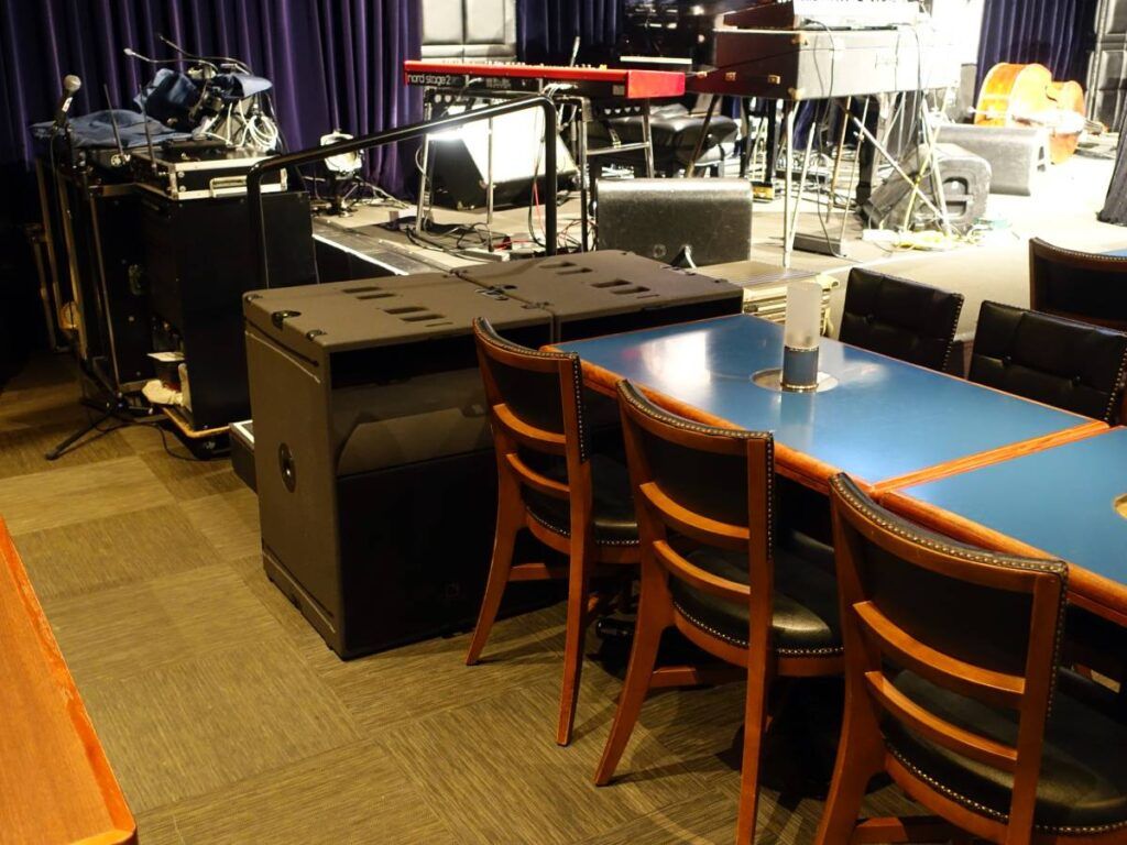 L-Acoustics KS21 subwoofers ground-stacked on either side of the Blue Note Tokyo stage